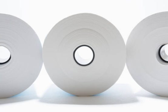 three rolls of white paper with black coils on white background, abstract background