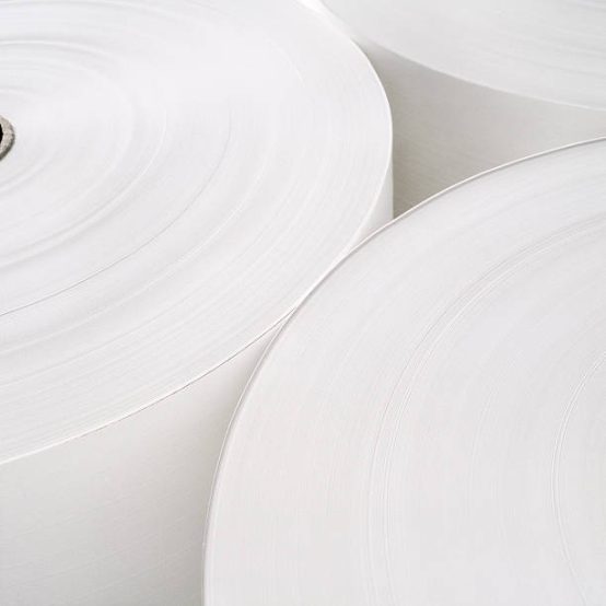 White color roll of paper. Abstract composition of three industrial rolls of paper conjuntion.Detail on the blades. Smooth circular shapes composition.